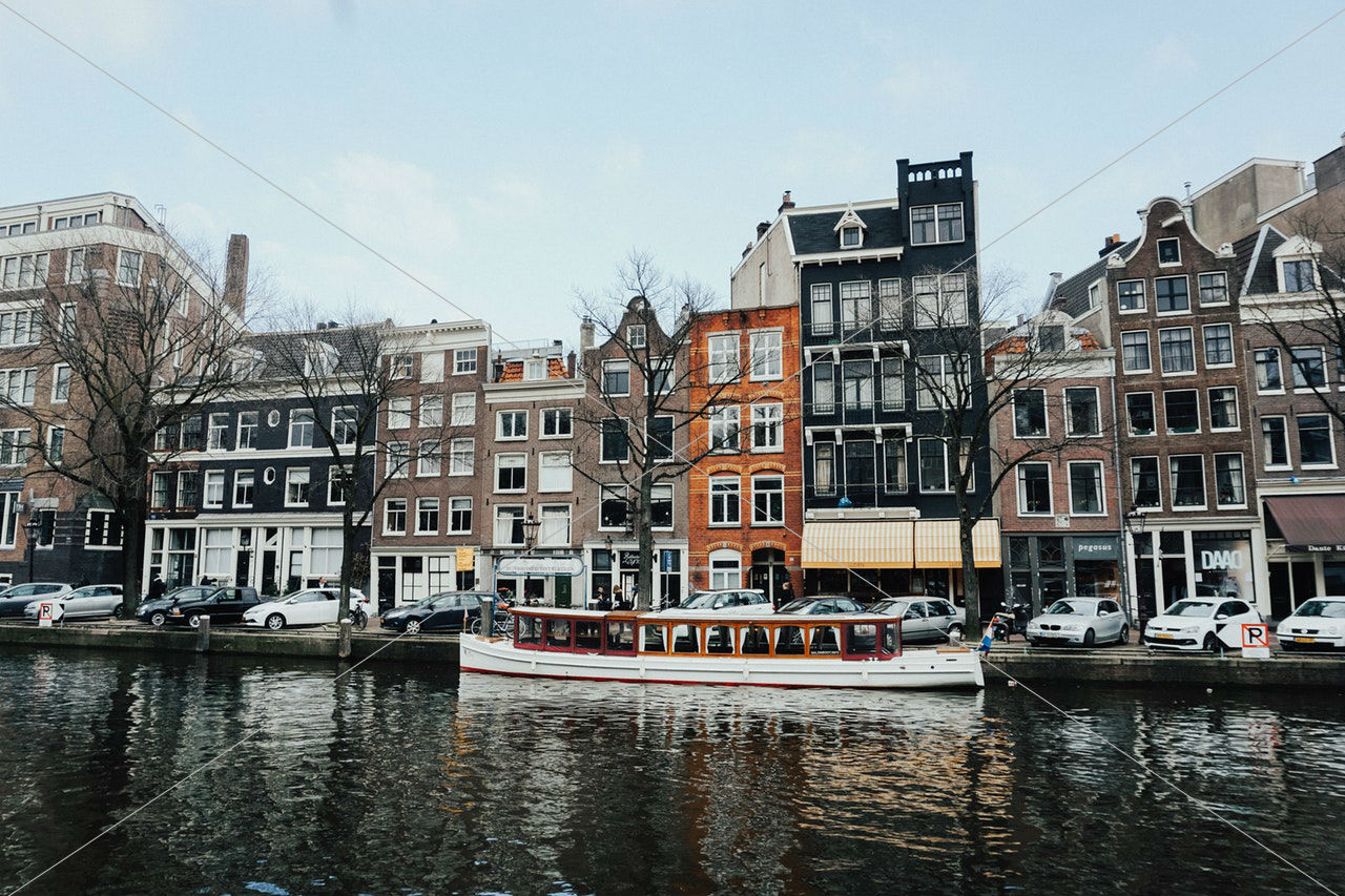 white and brown wooden boat on body of water